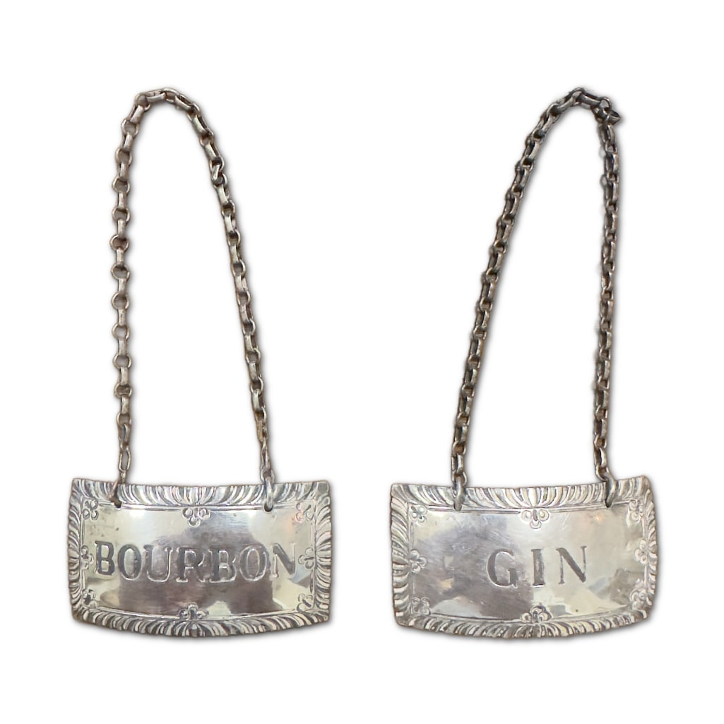 Pair of Antique Stieff Williamsburg Sterling Silver Decanter Tags: This Lot includes a Pair (2) of Stieff Williamsburg Sterling Silver Decanter Tags. Matched Set of Two (2) Sterling Tags. One (1) Marked Bourbon, One (1) Marked Gin. Both Measure 1"x2". The Bourb