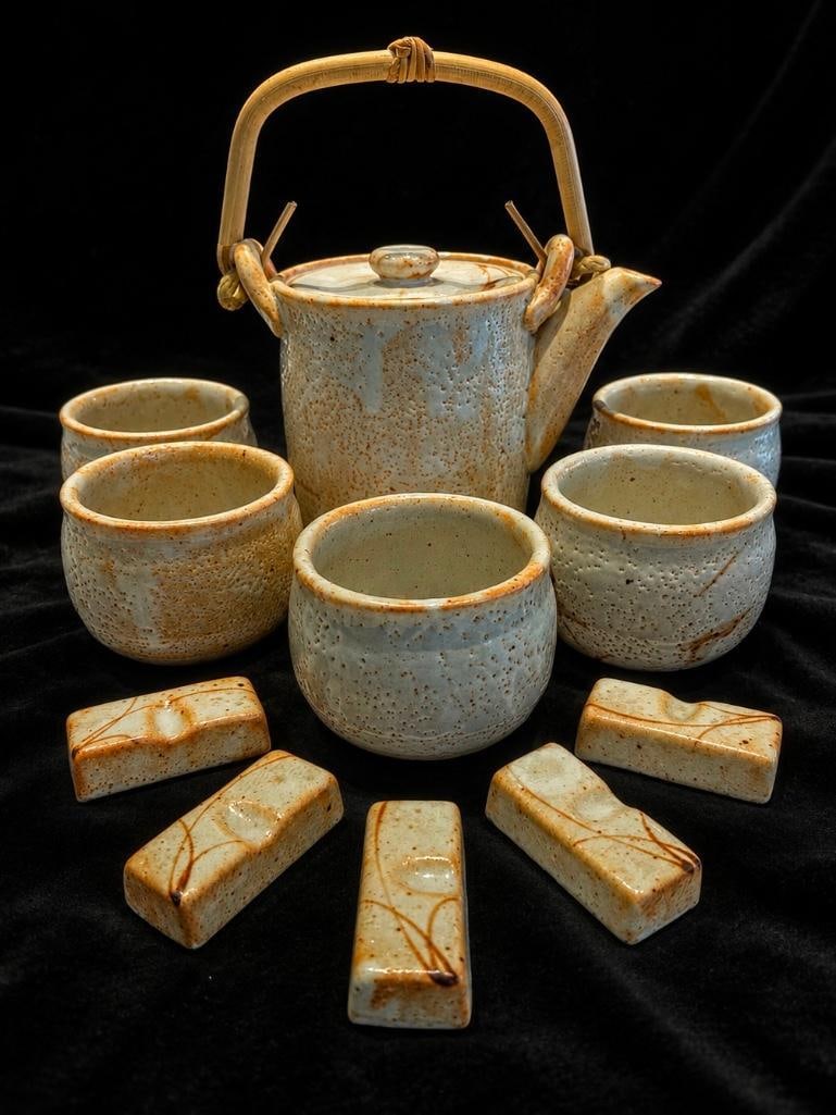 Japanese Stoneware Tea Set for Five: Japanese Stoneware Tea Set for Five. This lot includes one (1) teapot, five (5) cups and five (5) ceramic rests. This set is likely hand crafted and vintage, it is in excellent condition. The teapot