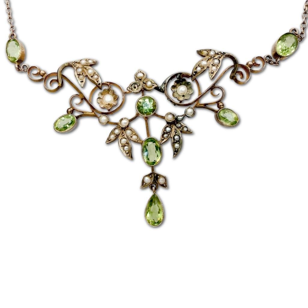 9k YG Edwardian Peridot & Seed Pearl Festival Garland Necklace: 9k Yellow Gold Edwardian Peridot & Seed Pearl Festival Garland Necklace. The Necklace Typically Dates from 1901-1910. The Scrolled, openwork Frame Features Stylized Leaf and Floral Motifs. The Ne