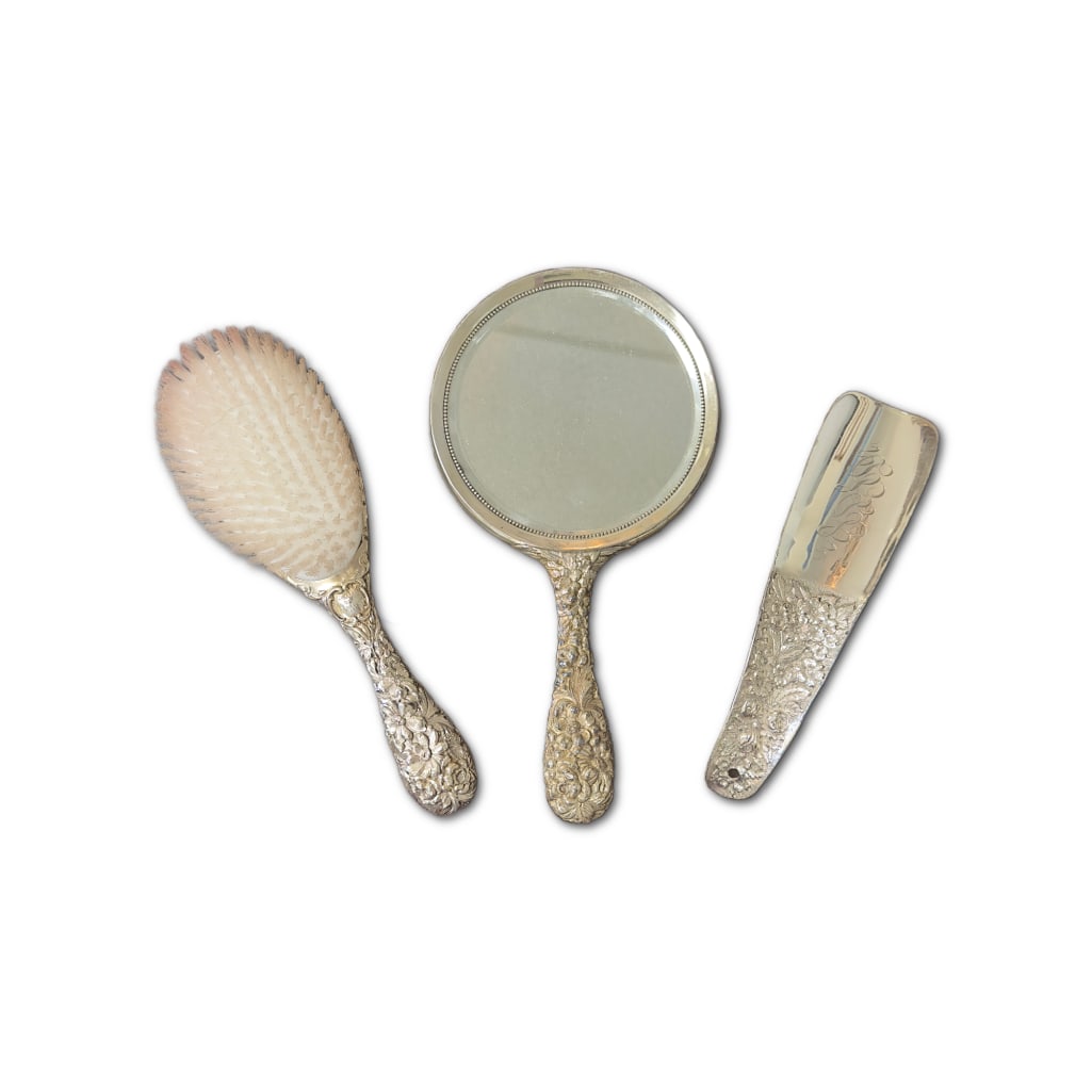 Victorian 3 Piece Stieff Sterling Dresser Set: Victorian 3 Piece Stieff Sterling Dresser Set in the "Rose" Pattern to Include One (1) 10" Sterling Silver Hand-Mirror, One (1) 10" Sterling Silver Brush, and One (1) 8" Sterling Silver Shoehorn.