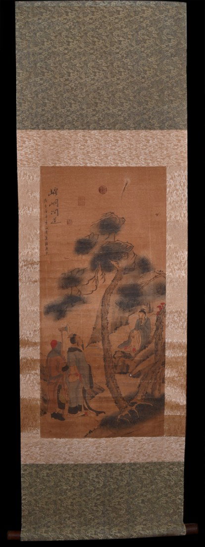 ZHEN RAN SCROLL PAINTING: Depicting figures with one in a tree, signed in top left and with three seal marks in red, on a silk brocade scroll. Painting measures 34" H x 15.75" W.