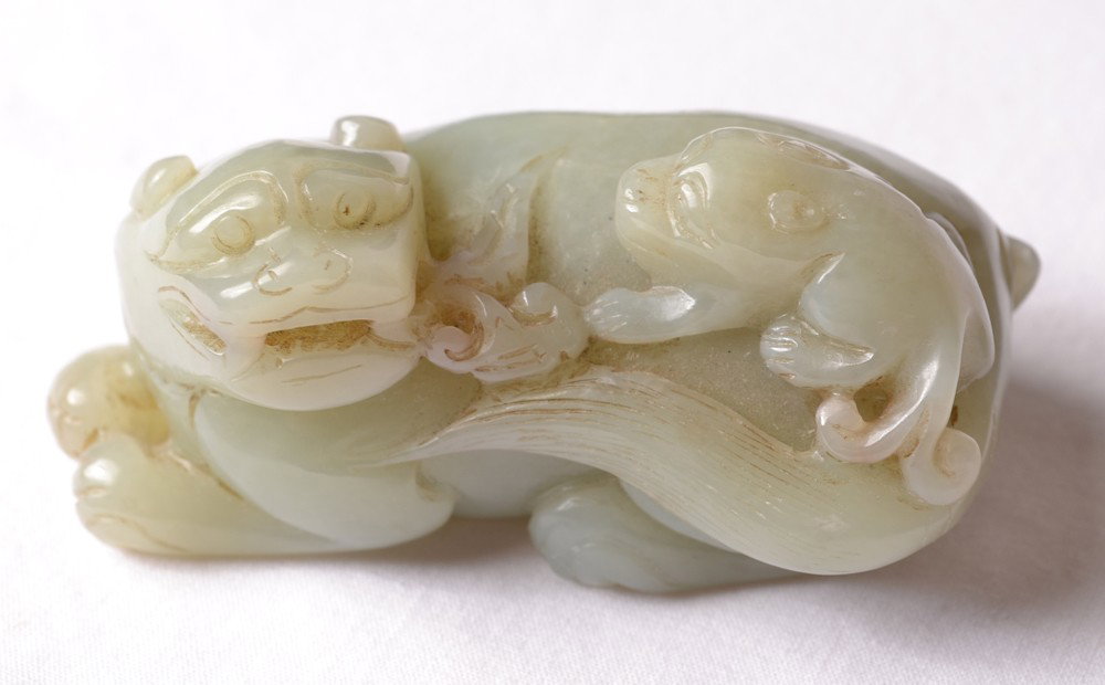 CARVED JADE FOO DOG: Carved foo dog holding ruyi in mouth and small foo dog on back. 3" L.