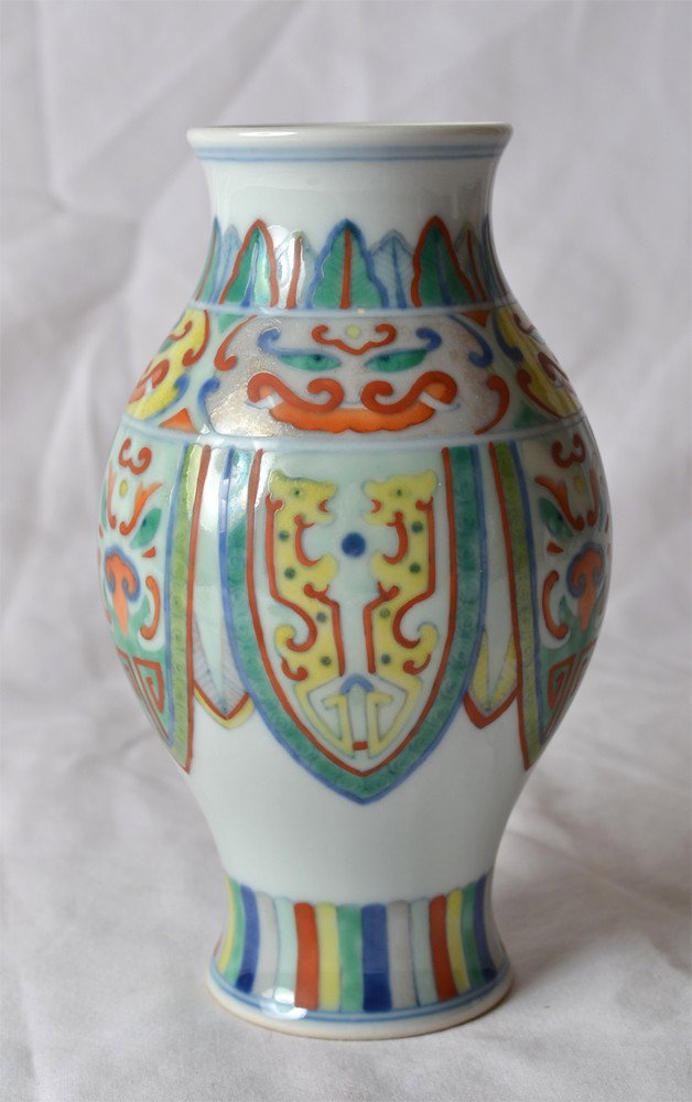 DOU CAI ZUN SHAPE VASE: Enameled with colorful masks and shields. Kangxi mark in blue. 6" H.
