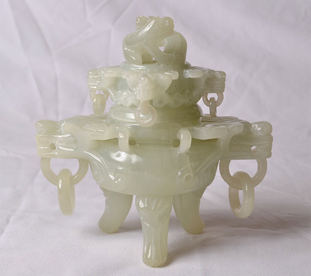 CARVED SOAPSTONE CENSOR: Lid with carved lizards handle, animal faces, and bottom with carved dragon heads, all with loose rings. 5" H x 5" L. Repair to one ring on bottom.
