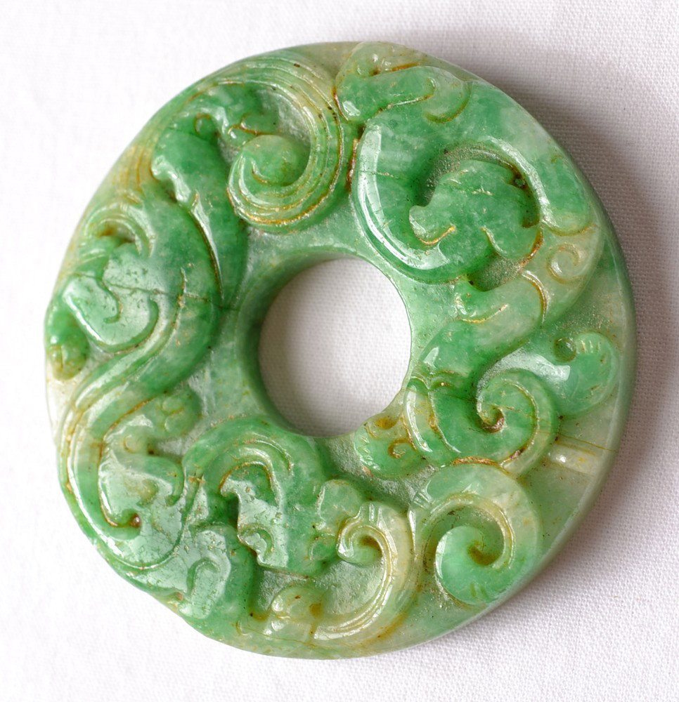 CARVED JADEITE DISC: Carved on one side with chilong, the other side carved into the shape of a coin. 2" DIA.