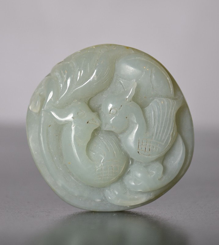 CARVED JADE BIRDS: Carved with two birds looking eye to eye. 2" W.