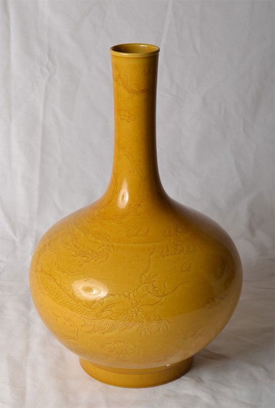 SAFFRON INCISED PORCELAIN VASE: In saffron yellow with with dragon and ruyi. Six character mark in black. 13.125" H x 8.25" W.