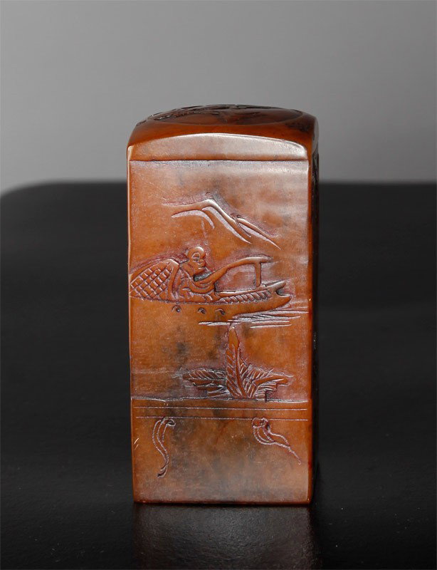 CARVED SOAPSTONE SEAL: All four sides carved with landscape, figures and birds. Bottom with four character mark. 3.25" H x 1.625" SQ. 20th century.