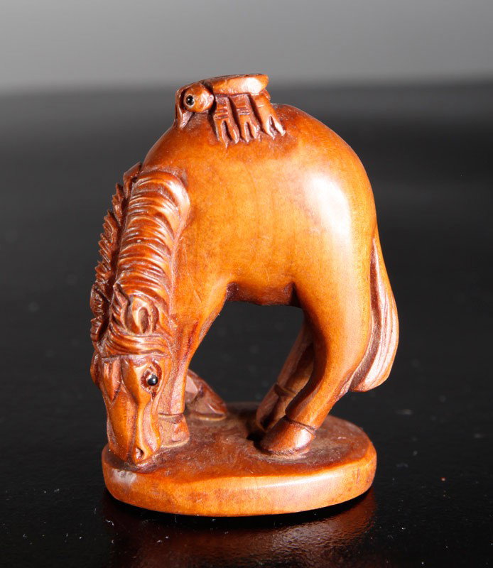 CHINESE CARVED HUANG YANG WOOD NETSUKE: Carved depicting a horse eating. 2.125" L.