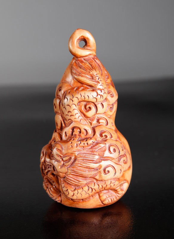 CHINESE CARVED HUANG YANG WOOD NETSUKE: Carved double gourd with dragon. 2.5" L.