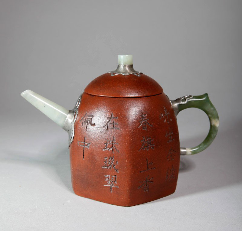CHINESE ZI SHA TEA POT: With jade handle, spout and top of lid applied with tin, with carved caligraphy to one side and mountain landscape to other side. Four character impressed mark. 4.25" H x 6.5" L.