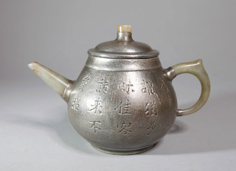 CHINESE TIN WRAPPED ZI SHA TEA POT: With jade handle, spout and top of lid, tin wrapped with caligraphy decoration. Four character impressed mark. 4.625" H x 6.625" L.