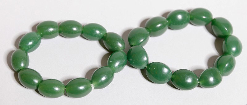 PAIR OF CHINESE MO YU JADE BRACELETS: Each with 11 uniform beads.