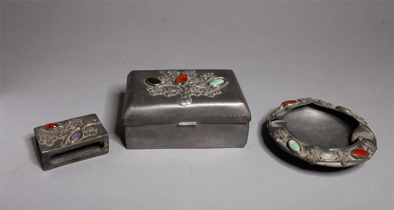 3 PIECE CHINESE EXPORT SMOKING SET: Pewter with jadeite, amethyst, jade and carnelian in apple blossom, includes a cigarette box, ash tray and match holder. Largest 4.75" L. Some denting to box and ash tray.