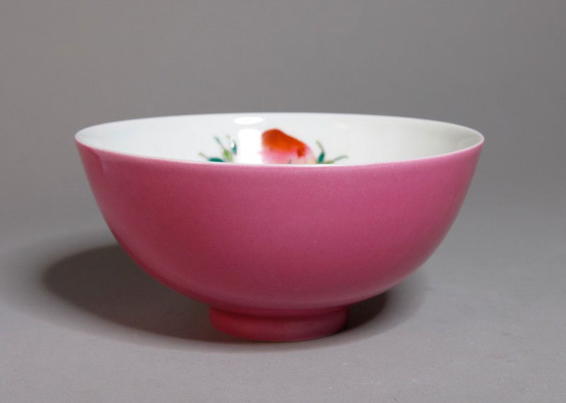 CHINESE FAMILLE ROSE PORCELAIN BOWL: Pink exterior, the interior with peach, chayote, pomegranet and symbol. Six character mark in two circles in blue. 2.5" H x 5.25" DIA.