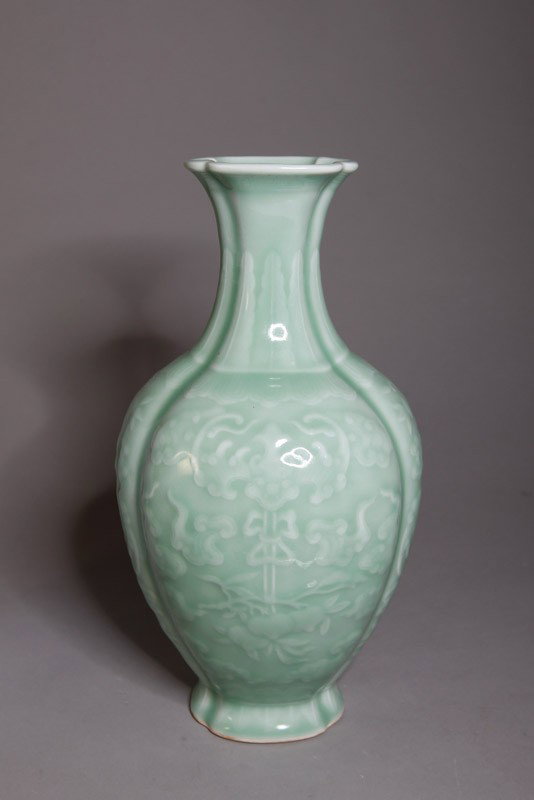 CHINESE CELADON PORCELAIN VASE: With bats, peaches and scrolling designs on four panels. Six character Qianlong mark in blue. 11.25" H.