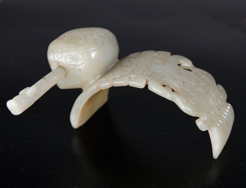 CHINESE HAN DYNASTY JADE HAIR ORNAMENT: 2 piece hair ornament, top with carved scrolling and face design, with carved pin to fit. 1.875" H x 3.5" L.
