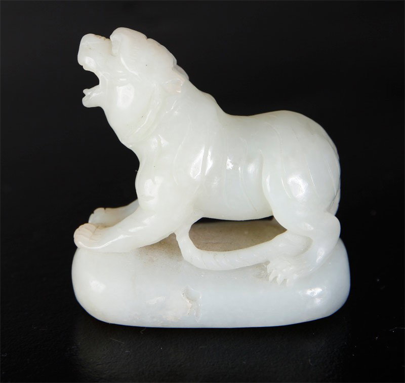 CHINESE JADE FOO DOG: Standing on a pedestal, carved foo dog with open mouth. 2.125" H x 2.125" L.