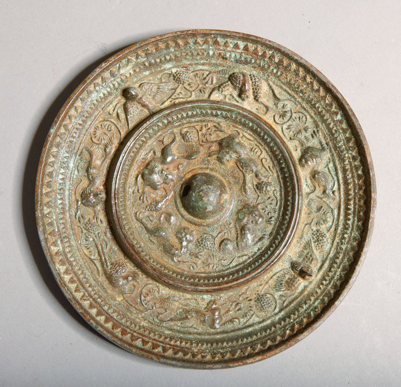 CHINESE BRONZE HAND MIRROR: Molded with various birds and other animal figures and flowers. 4.875" DIA.