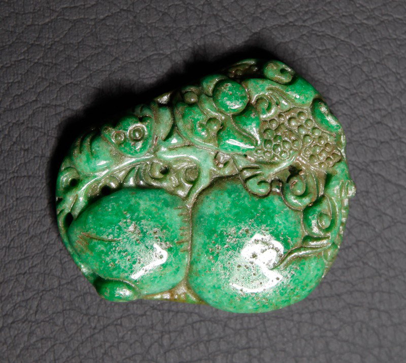 CHINESE CARVED JADE PLAQUE: One side carved with peaches, other side carved with ruyi and bats. 2.125" L.