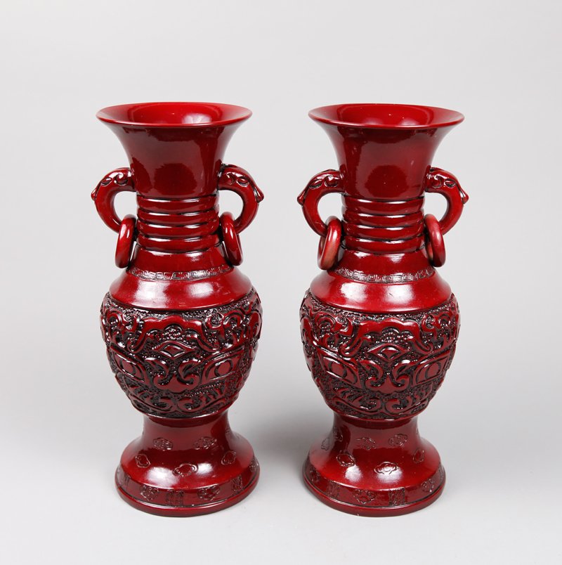 PAIR OF CHINESE PORCELAIN VASES: In oxblood glaze, molded with dragon mask, two handles with loose rings, clouds and Greek key design. Six character circular mark on underside. 12.375" H. Excellent condition.