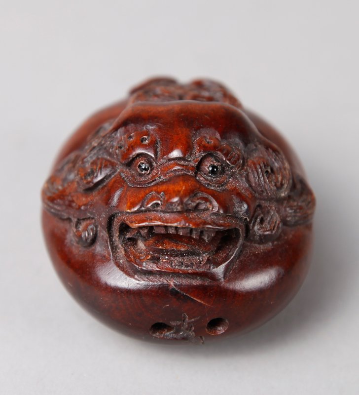 CHINESE CARVED BOXWOOD NETSUKE: Carved depicting a dragon head and tail atop egg. 2.25" L. Excellent condition.