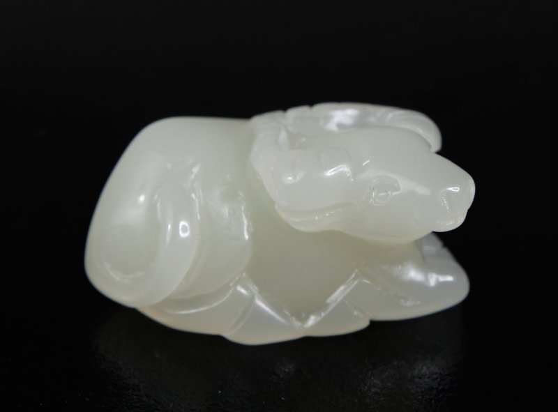 CHINESE JADE OX: Reclining ox with carved horns and raised head. .75" H x 1.875" L.