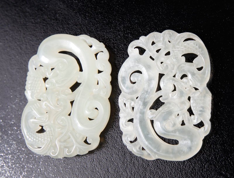 PAIR OF CHINESE CARVED JADE PLAQUES: Each carved on both sides with dragon and scroll designs, only slightly different from eachother. 1.5" H x 2" L.