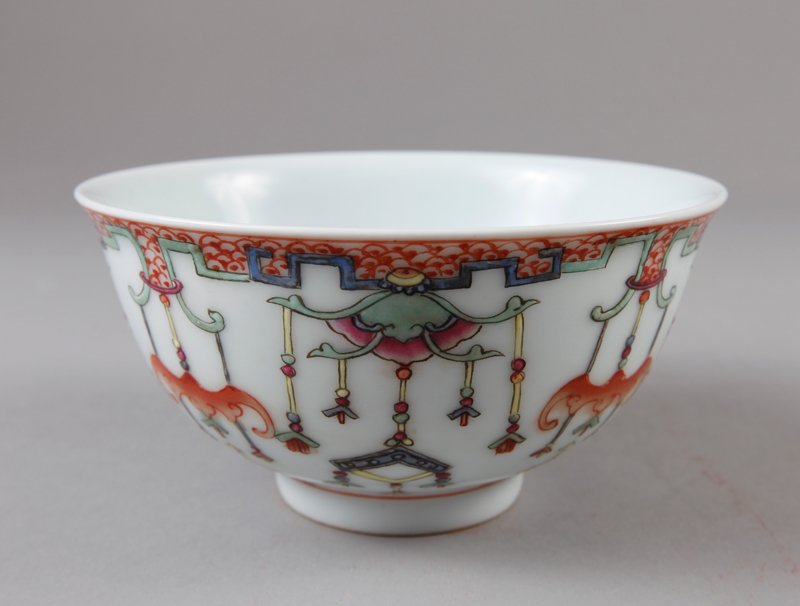 CHINESE FAMILLE ROSE BOWL: With precious objects, bats and beads. Six character faint mark in red. 2.5" H x 4.875" DIA.