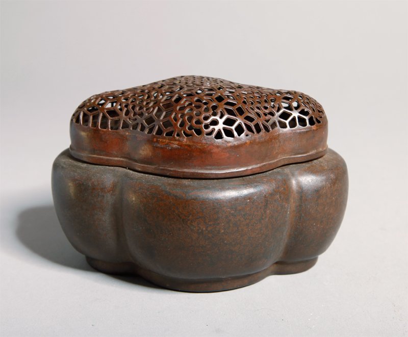 CHINESE BRONZE HAND WARMER BY ZHANG MINGQI: Cartouche shape with openwork lid with floral designs. Etched signature on bottom. 2.75" H x 4" L.