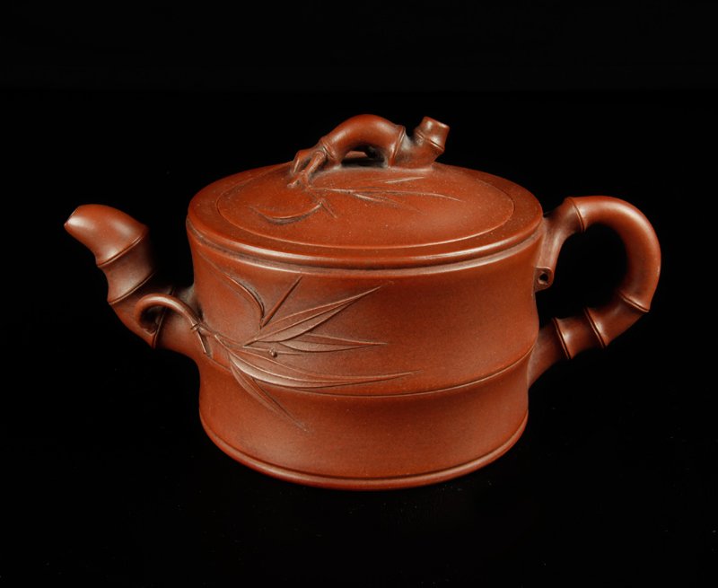 Chinese Yixing Clay Tea Pot: Of bamboo form with bamboo handles, spout and leaves. Four character mark on underside. 3.75" H x 6.75" L. Excellent condition.
