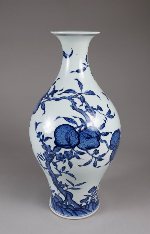 CHINESE BLUE AND WHITE VASE: With cascading peaches and flying bats throughout. Six character mark in two circles in blue. 14.75" H x 7.5" W.