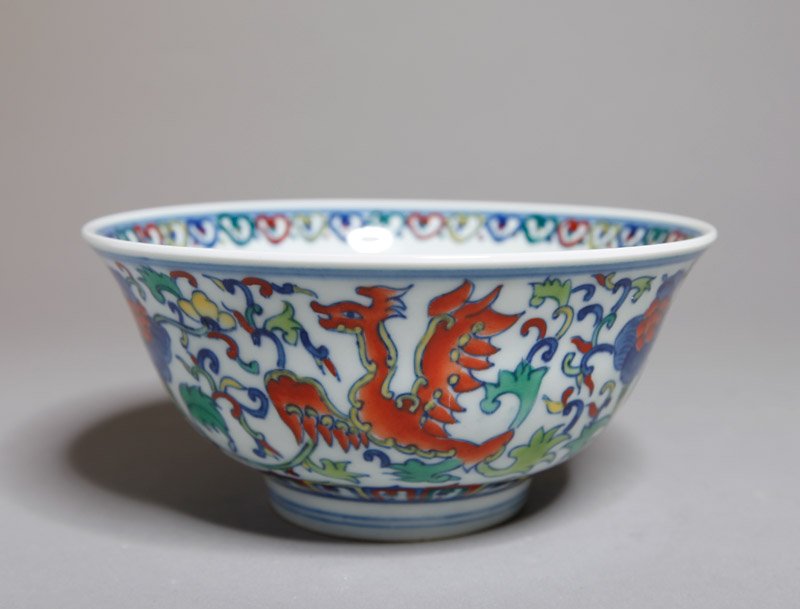CHINESE DOU CAI PORCELAIN BOWL: Inside with floral medallion, outside with Phoenix, flowers and vines. Six character mark in blue. 2.625" H x 5.5" DIA.