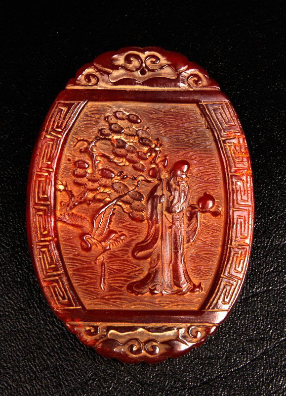 Chinese Carved Horn Plaque: Oval form, carved on one side depicting God of Longevity with crane and lingzhi, the other side carved with intricate chilong. 3.25" H x 2.375" W. Excellent condition.
