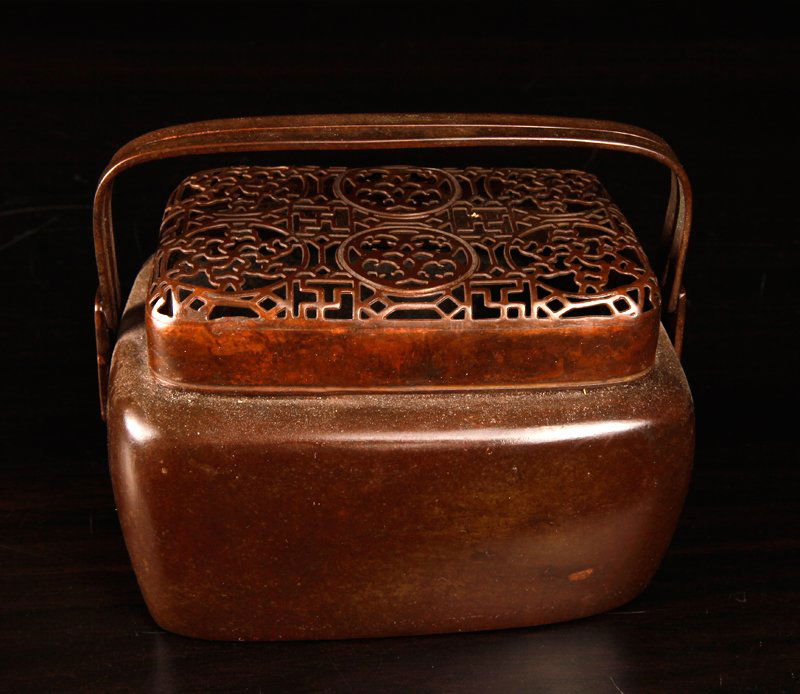 Chinese Bronze Hand Warmer: Rectangular form with two handles, the top pierced depicting symbols within circles. Three character mark on underside. 3.125" H x 5" L x 3.375" W. Excellent condition.