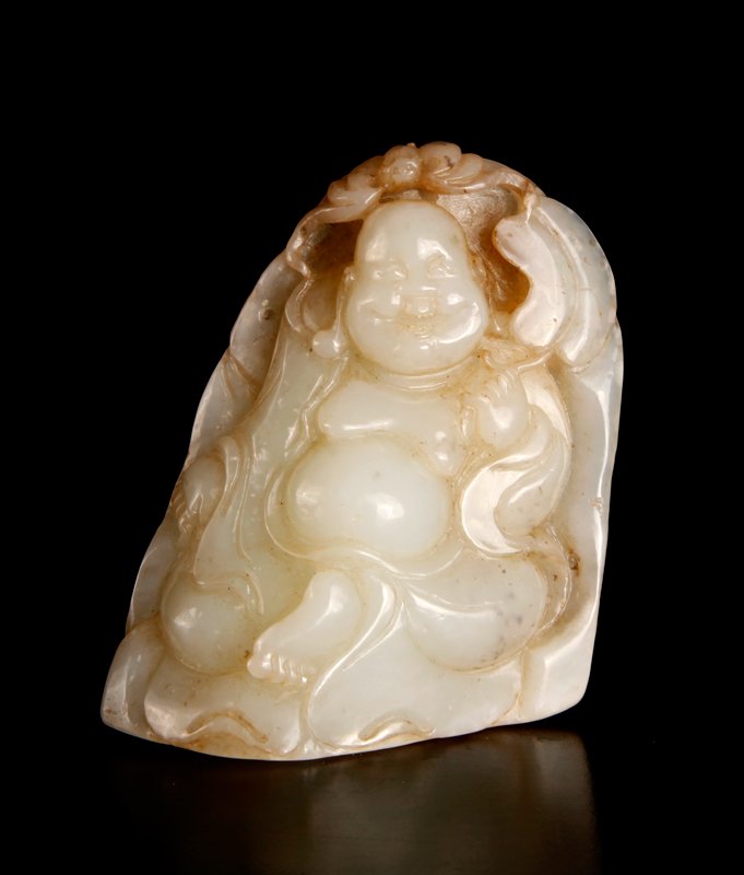 Chinese Carved Jade Buddha: Finely carved depicting a seated Happy Buddha with bat at his head, in a light celadon with black and russet inclusions. 3.75" H x 2.875" W x 1" D. Excellent condition.