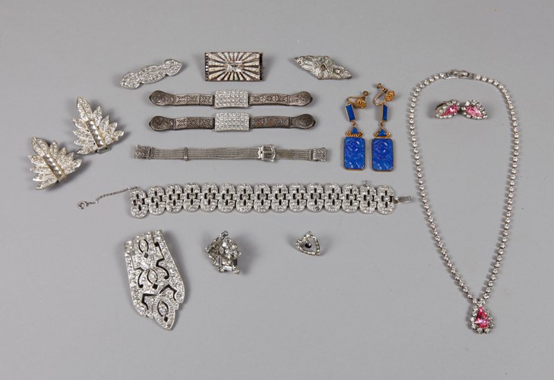 17 Piece Art Deco Jewelry: Most with rhinestones, includes a necklace/earrings suite, shoe clips, pins, bracelet, and earrings.