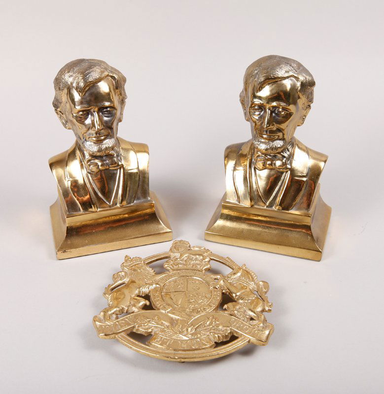 Pair of Brass Lincoln Bookends & Kings Arms Trivet: Includes a pair of Lincoln bust bookends, unmarked with felt bottoms. Together with a brass Kings Arms trivet dated 1953, with coat of arms. Bookends measure 7.25" H x 4.75" W. Excellent condition.