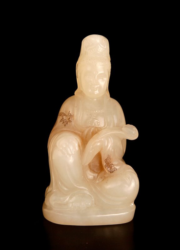 Chinese Carved Jade Guan Yin: In very light celadon to white jade, carved to depict a seated Guan Yin holding ruyi, with floral etchings on her robe colored. 4.875" H x 2.375" W x 2.125" D. Excellent condition.