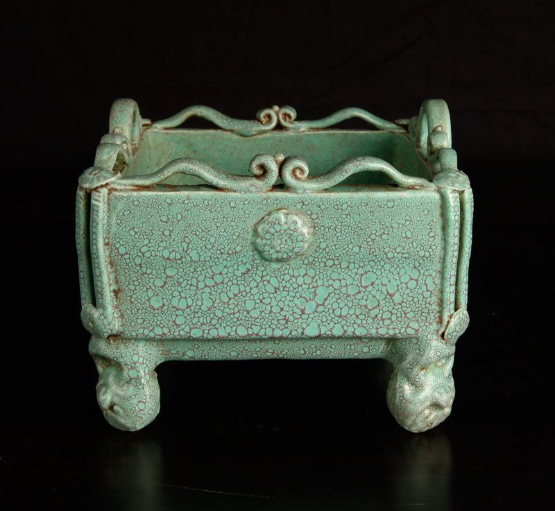 Chinese Porcelain Censer: In green mottled glaze, the top with scrolled handles, resting on four upside down lion and ring feet. Carved Qianlong mark on underside. 4.375" H x 5.375" Sq. Excellent condition.