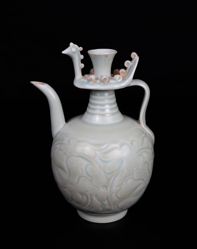 Chinese Celadon Glaze Porcelain Tea Pot: The top decorated with birdlike figure with protruding scrolls, the base incised with large floral and leaf designs. 8.25" H x 4.875" W. Excellent condition.
