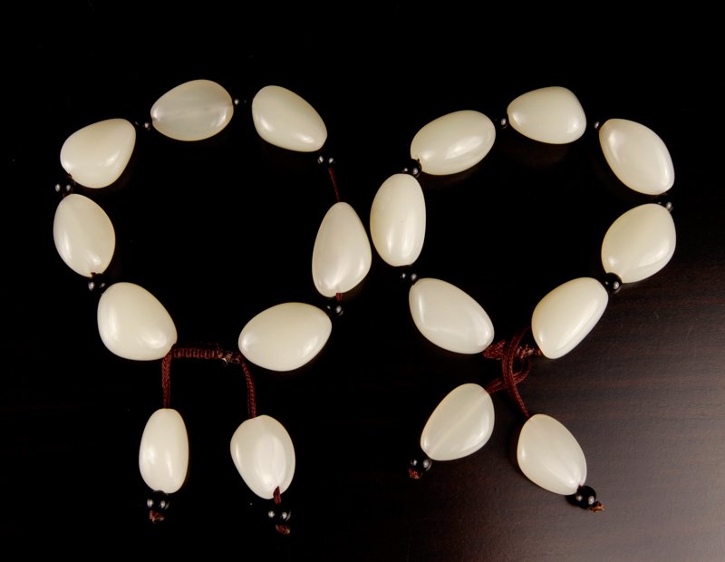 Pair of Chinese Hardstone Bead Bracelets: Light celadon, each with seven oval type beads and two beads for tassels. Excellent condition.