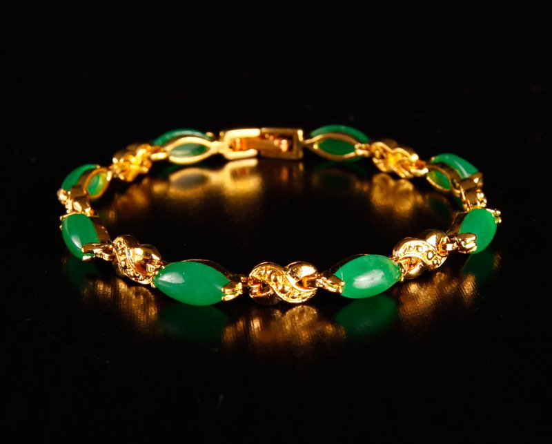 Chinese Hardstone Bracelet: Mounted in gold colored metal, with oval shape jade stone. 6.5" L. Excellent condition.