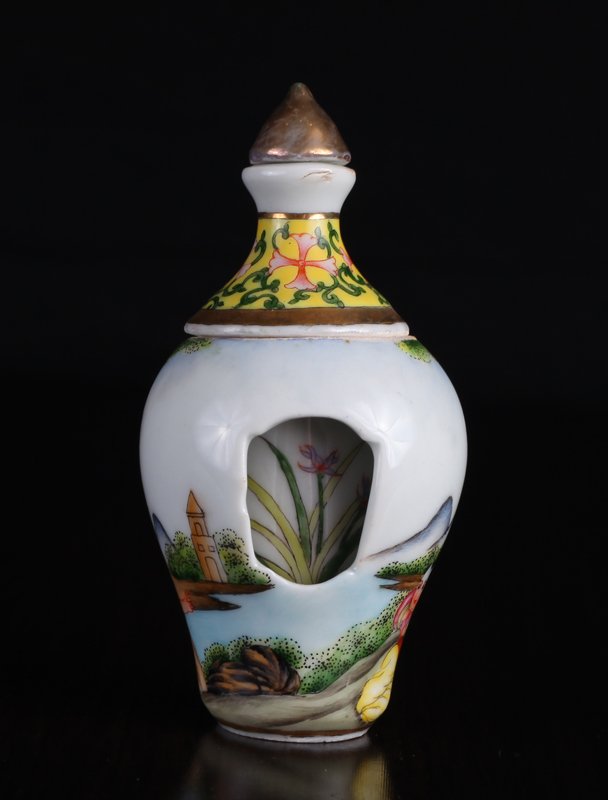 Chinese Revolving Porcelain Snuff Bottle: Painted to depict a mother and her children at a water/mountain setting. One side opening to reveal revolving center with floral designs. Center moves freely. Four character mark in blue on underside.