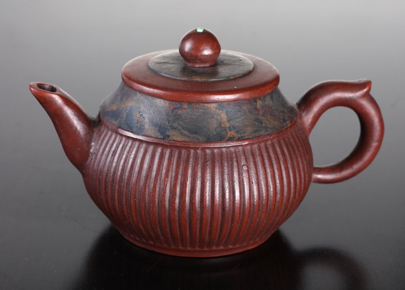 Chinese Zi Sha Pottery Tea Pot: Marbling around top rim and on lid, the body with vertical ribbing. Four character impressed mark on underside. 3.75" H x 6" L. Excellent condition.