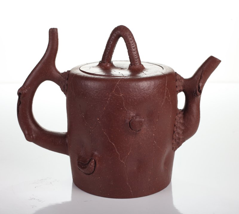 Chinese Zisha Clay Teapot: In crackle wood form with protruding funghi. Character mark to interior lid, three character mark on underside. 5.875" H x 7.5" L x 4.25" W. Excellent condition.