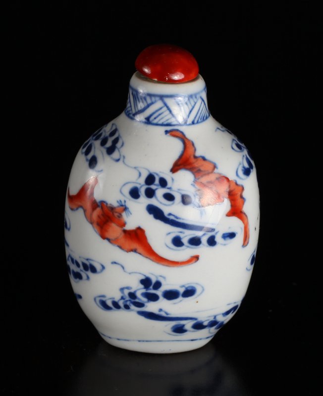 Chinese Blue & Red Porcelain Snuff Bottle: Depicting flying bats amid ruyi. Four character mark in iron red on underside. 3" H x 1.75" W. Excellent condition.