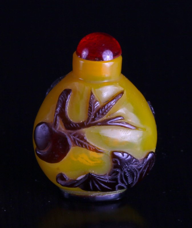 Chinese Peking Glass Snuff Bottle: In Imperial yellow glass, overlayed in purple depicting bats and peaches. 2.125" H x 1.5" W. Excellent condition.