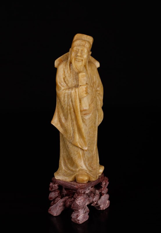Chinese Carved Soapstone Figure: Finely carved to depict a three-dimensional elder figure holding a scroll. Signed on underside. 7.875" H x 3" W. Excellent condition.