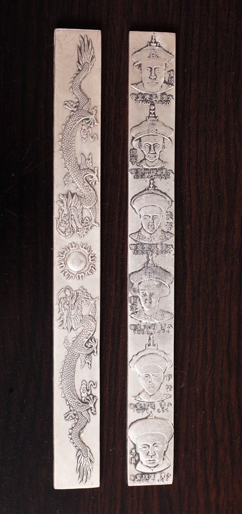 2 Chinese Silver Plated Paper Weights: One depicting dragons, the other depicting various busts with birth and death dates. Each with two character mark on reverse. 9" L x .875" W. Excellent condition.